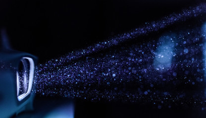 Projector light illuminating dust in darkness