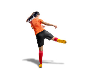 Rear view of asian football player woman in orange jersey with kicking the ball