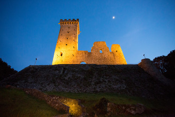 Fototapeta premium ruins of medieval castle in moonlight in the village of castelnuovo magra tuscany italy