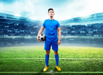 Asian football player man holding the ball in the middle