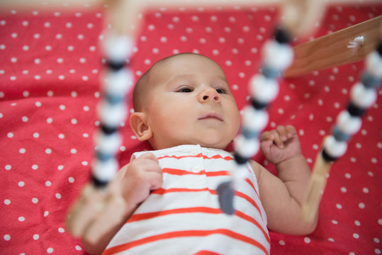 Baby Plays in a Wooden Gym