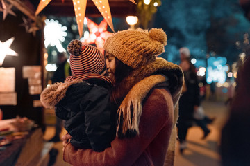 Loving mother with child on winter fair