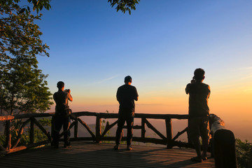 Fototapeta na wymiar KANCHANABURI PROVINCE, THAILAND - MARCH 30, 2019: People take photos the sunrise at the viewpoint, Thong Pha Phum National Park, Kanchanaburi, Thailand