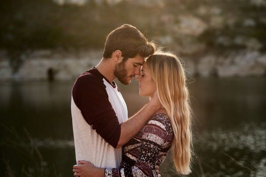 Bearded man with blonde woman hugging