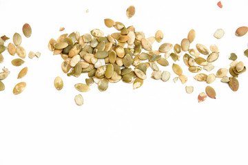 Peeled pumpkin seeds isolated on white background.Top view