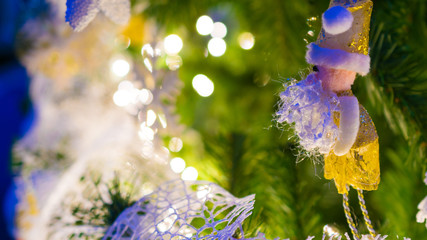 santa claus puppet hanging in christmas tree as decoration in a beautiful christmas tree