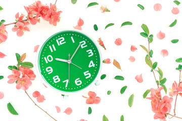 Vintage alarm clock flat lay with colorful springtime decoration
