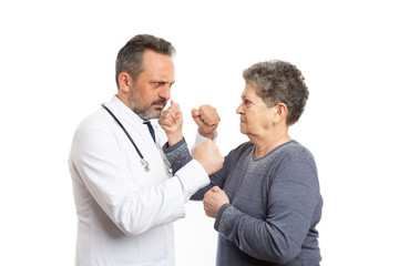 Doctor and patient fighting with fists