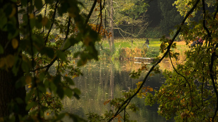 view from the park of Bremen Germany, autumn with brightly colored leaves, and reflection of water