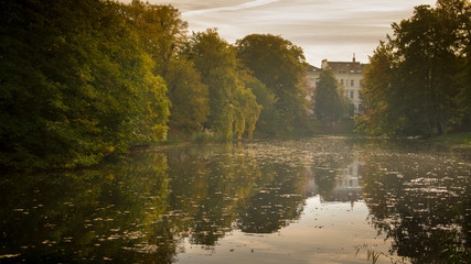 view from the park of Bremen Germany, autumn with brightly colored leaves, and reflection of water