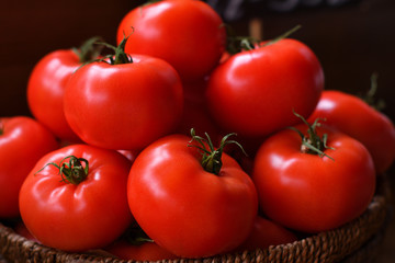 large red tomatoes in a wooden basket