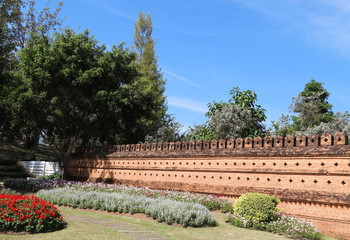 Scenery of vintage brick wall of public park with natural  and blue sky background in sunny day. 