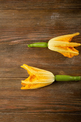 Baby zucchini on wood background