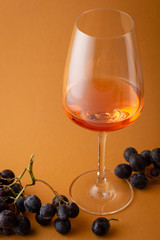 One glass of wine and grapes