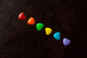 LGBT sweet flag: rainbow colored caramels lie in a row