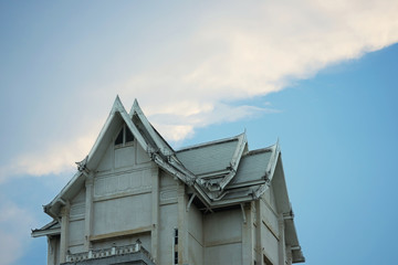 Old vintage Thai styled building or architecture on blue sky background