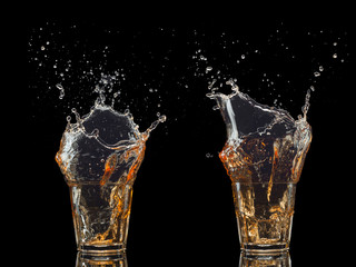 Isolated set of whiskey with splash on black background