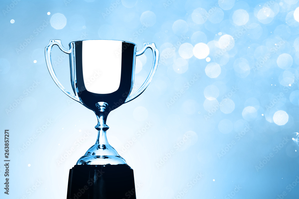 Wall mural silver trophy competition award on the abstract blurred light background with copy space, blue tone