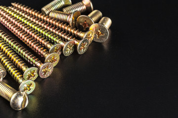 screws on black background
