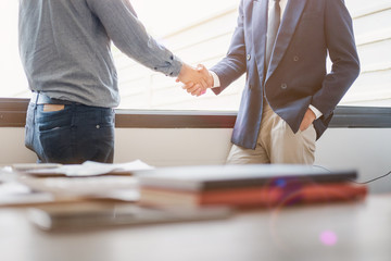Fototapeta na wymiar Business people shaking hands in meeting room, Successful deal after meeting.