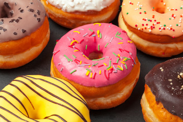 Glazed colored donuts background image. Macro shot