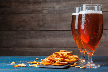 A selection of beer and snacks on wooden background