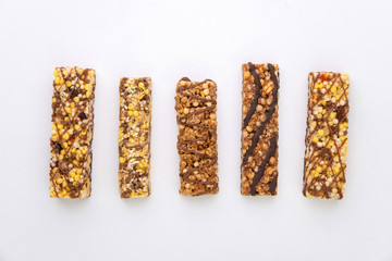 vegan dessert: several cereal bars with raisins and honey, isolated on white, short focus