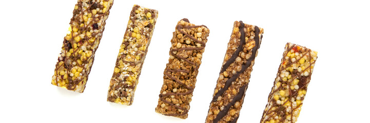 vegan dessert: several cereal bars with raisins and honey, isolated on white, short focus