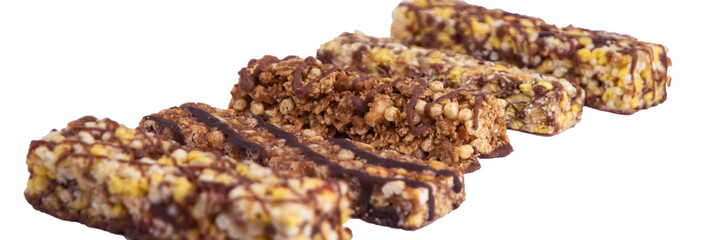 vegan dessert: several cereal bars with raisins and honey, isolated on white, short focus
