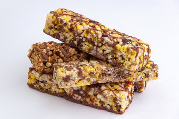 vegan dessert: several cereal bars with raisins and honey, isolated on white, short focus