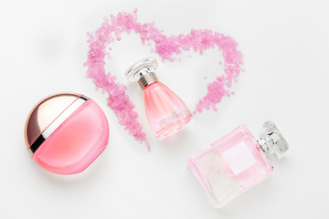 Bottle of perfume with red hearts