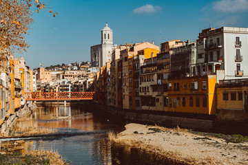 Colorful yellow and orange houses and famous house Casa Maso reflected in water river Onyar