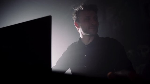 The Administrator of a Night Club Telling a Funny Story. A Young Man Talking Behind a Computer.