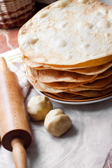 Cooking cake Napoleon - baked cake layers, raw dough and rolling pin