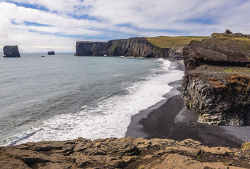 Dyrholaey foreland located on the south coast of Iceland, view from Kirkjufjara beach