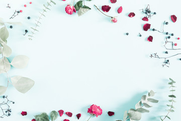 Autumn creative, modern composition. Frame made of berries, eucalyptus leaf, dry roses, petals on white background. Autumn, fall elegant concept. Flat lay, top view, copy space