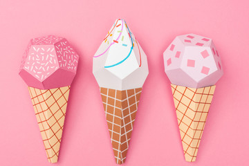 top view of handmade colorful origami ice cream cones isolated on pink - obrazy, fototapety, plakaty