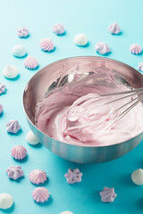 Whipped egg whites and colorful meringue cookies