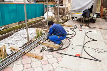 Fototapeta premium a man cuts metal squares with a grinder