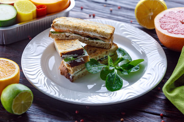 Sandwich with cheese, greens and salmon on toasted whole grain bread toast