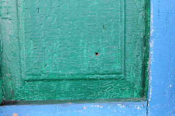 Old wooden background with remains of pieces of scraps of old paint on wood. Texture of an old tree, vintage wood background peeling paint. old blue board with cracked paint