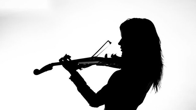 black silhouette on white background young girl in tight black leather clothes expressively plays the electric violin