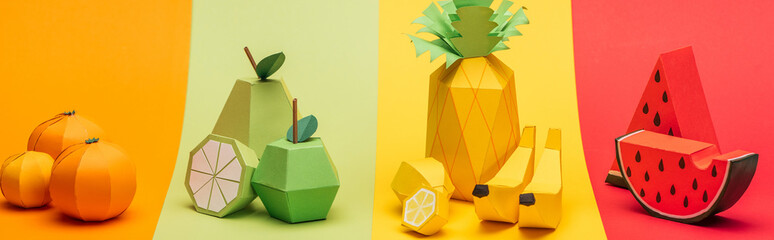 panoramic shot of various handmade origami fruits on stripes of colorful paper