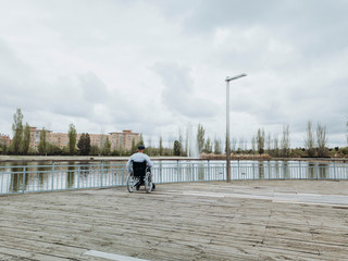 43 year old male sitting on a wheelchair in the park