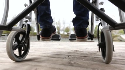 43 year old male sitting on a wheelchair in the park