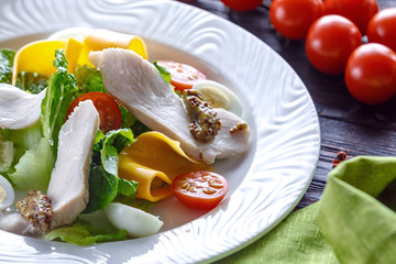 Salad of turkey with greens cheese and tomato and french mustard.