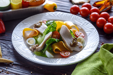 Salad of turkey with greens cheese and tomato and french mustard.