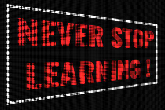 Never Stop Learning  red word on dark screen