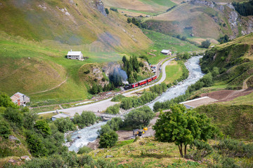 Realp, Furka - July 15, 2018: the vintage steam train going through the Raelp valley in Canton Uri, Switzerland