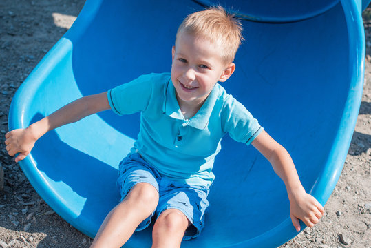 Concept of children life. Little child having fun in park. Happy child playing in the nature . Kid having fun outdoors